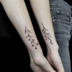 Matching flower tattoos on forearms