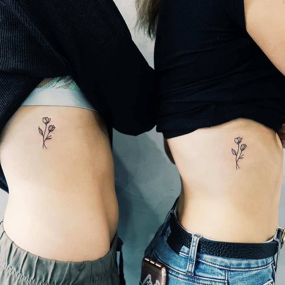 Matching friendship flower tattoos by Cholo