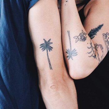 Matching palm tree tattoos by Kelli Kikcio