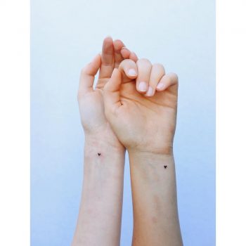 Mini heart tattoos for sisters by tattooist Zaya