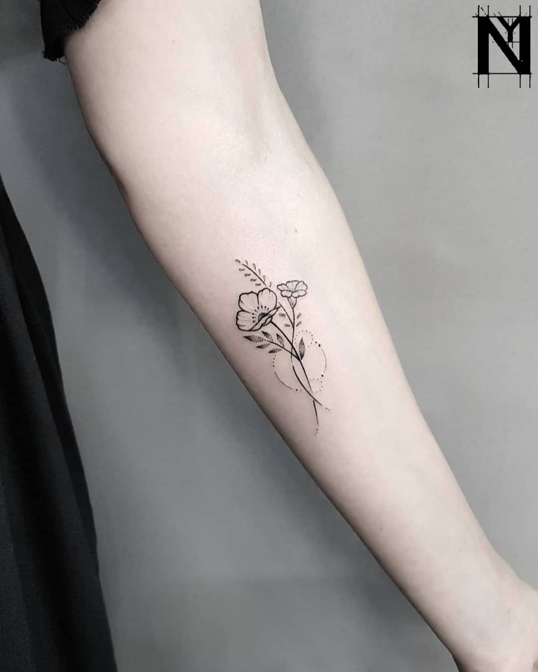 Minimalist floral bundle tattoo by Noam Yona