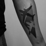 Negative space airplane tattoo
