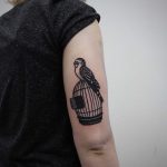Parrot on a cage tattoo