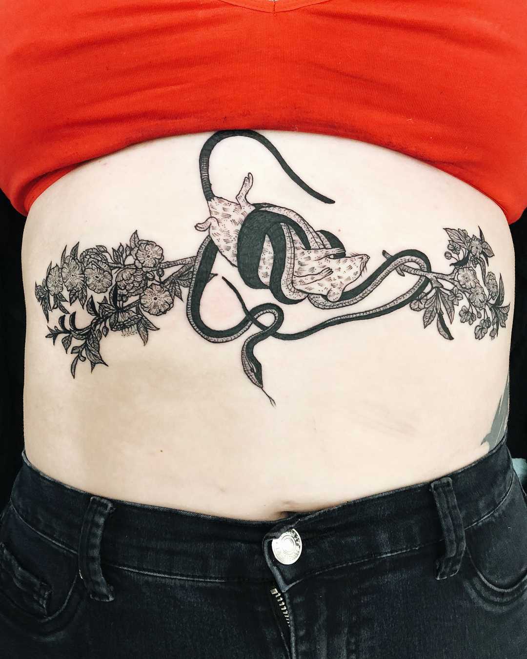 Rat, snake, and flowers tattoo