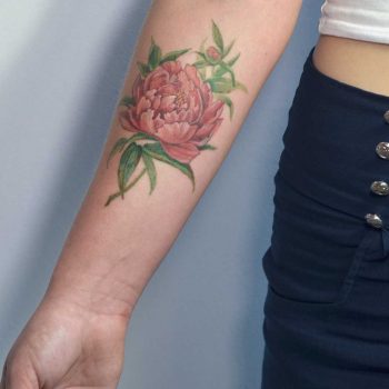 Realistic peony tattoo on the forearm