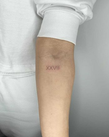 Roman numerals tattoo by Conz Thomas