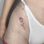 Rose tattoo on a hip by Conz Thomas