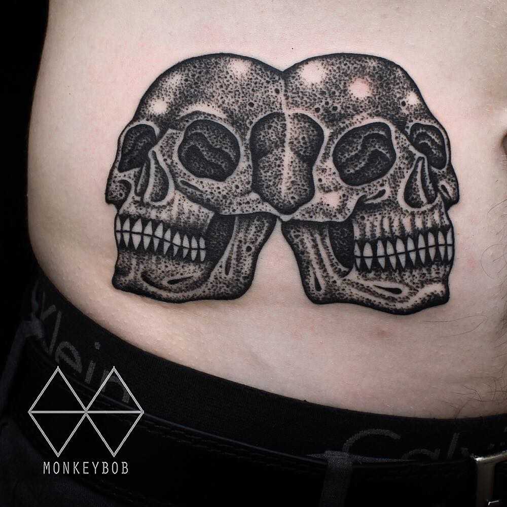 Siamese skulls tattoo