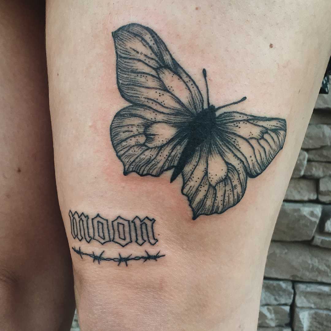 Simple butterfly tattoo on the thigh