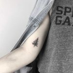 Small black tree tattoo on the right bicep