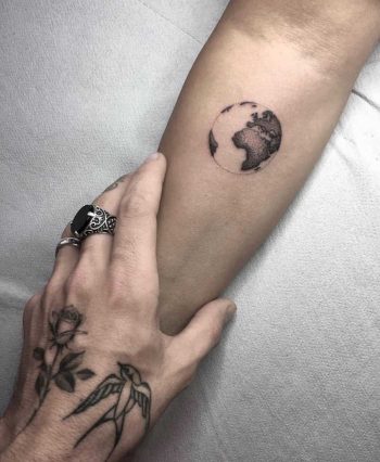 Small earth tattoo on the arm