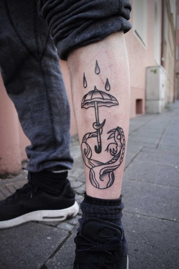 Snake with umbrella tattoo