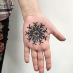 Snowflake tattoo on the palm by Łukasz Krupiński