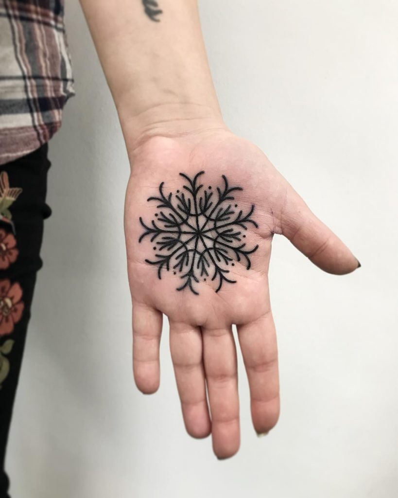 Snowflake tattoo on the palm by Łukasz Krupiński