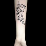 Solid black branch with leaves tattoo