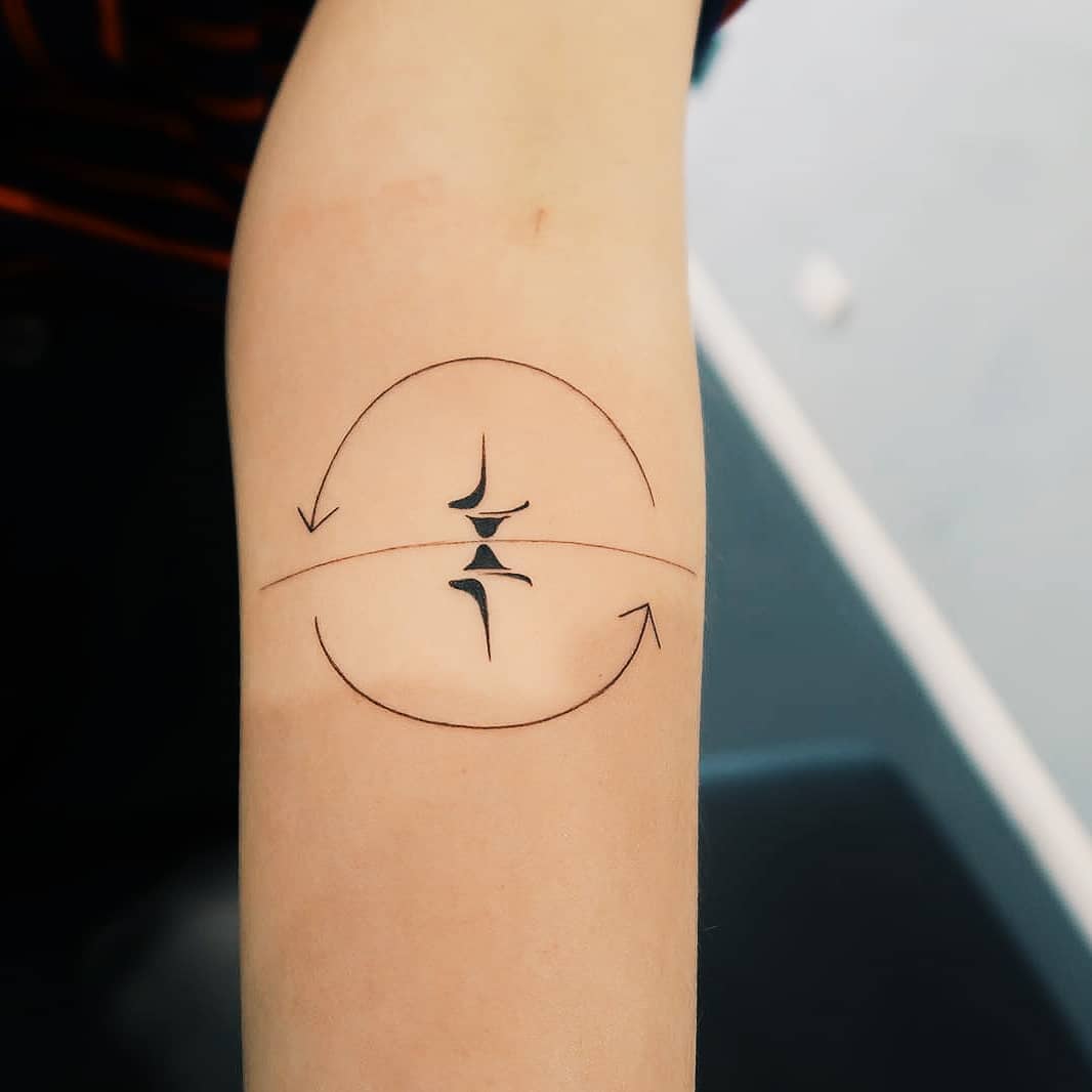 Spinning top tattoo by artist Cholo