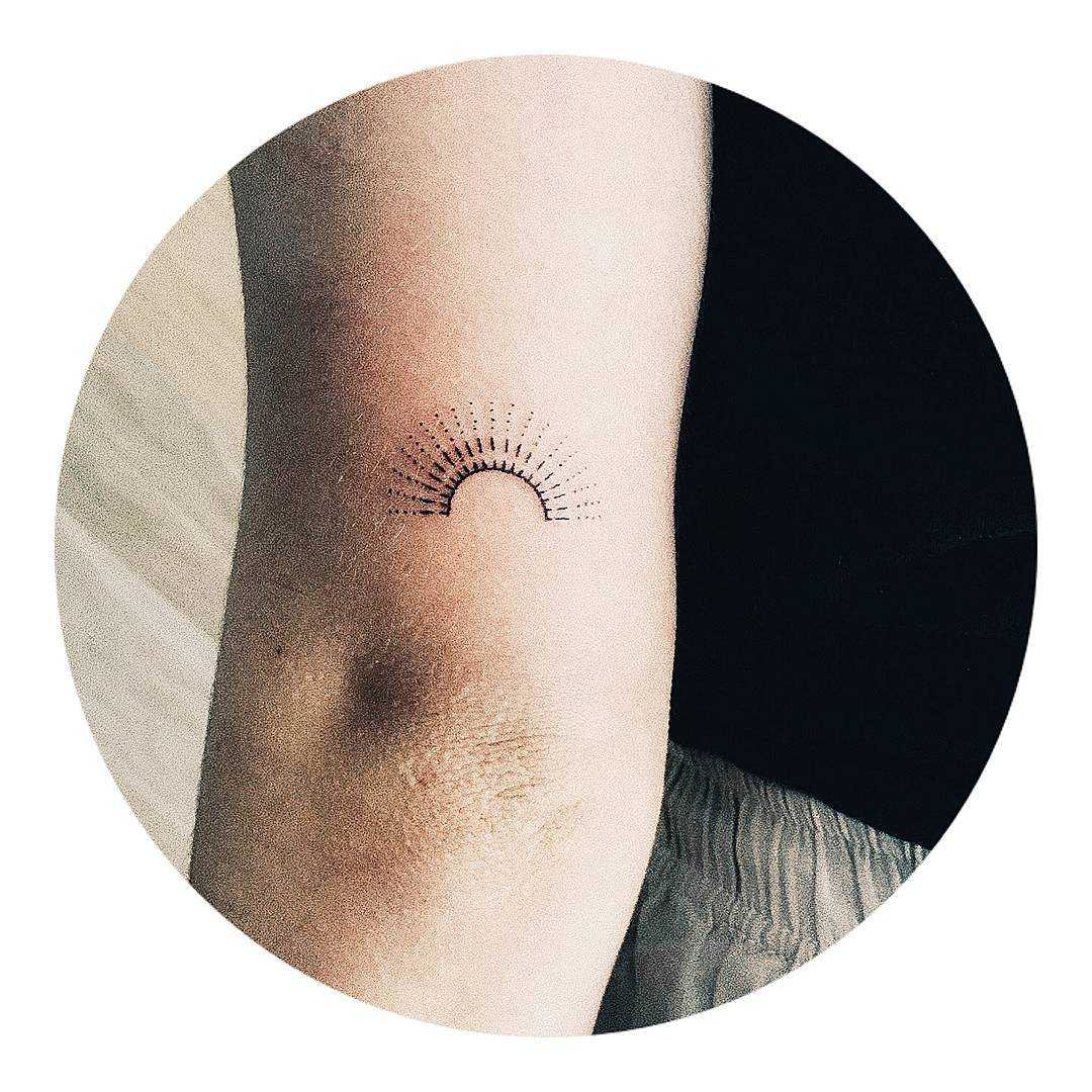 Stick and poke sun tattoo by Kate Kalula