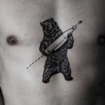 Tattoo of a bear with a bullet