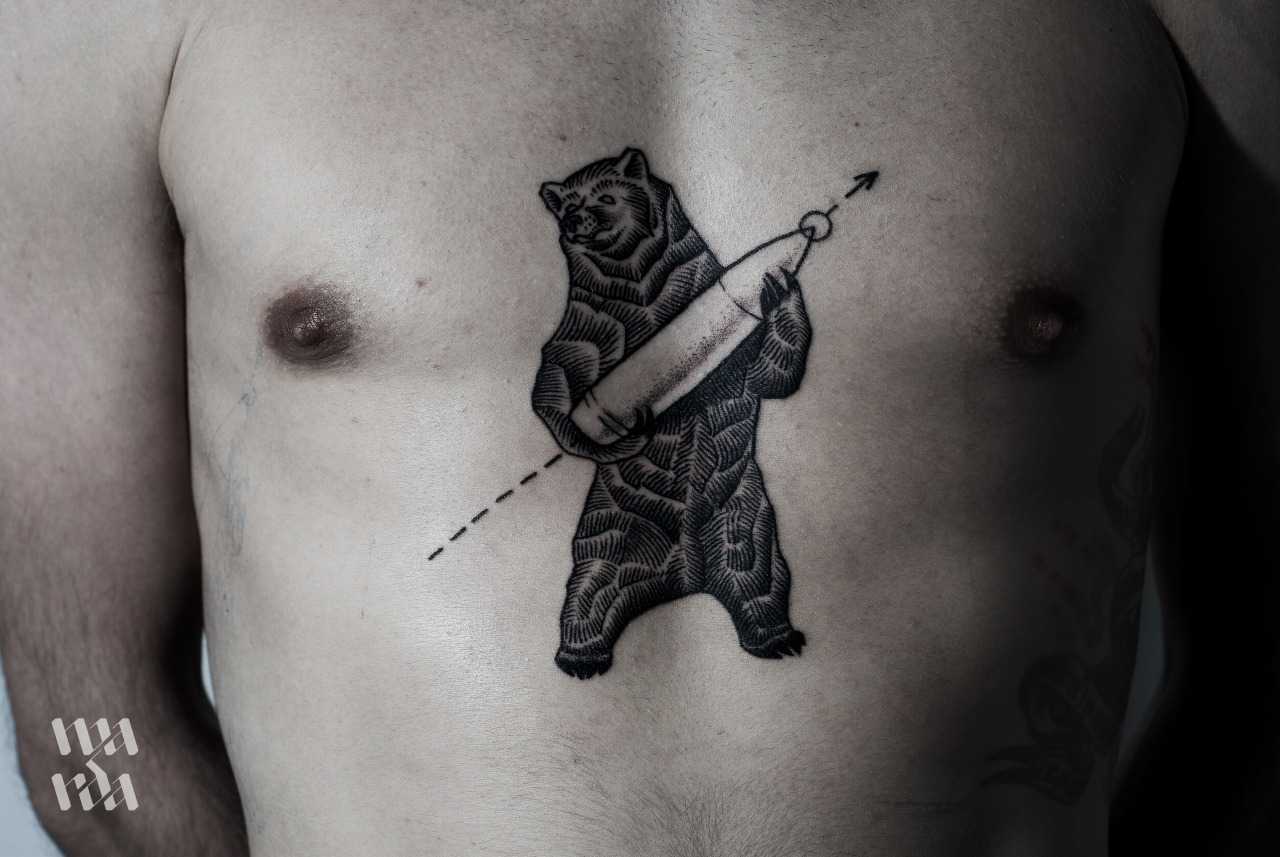 Tattoo of a bear with a bullet