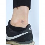 Tiny ankle flower by tattooist Zaya