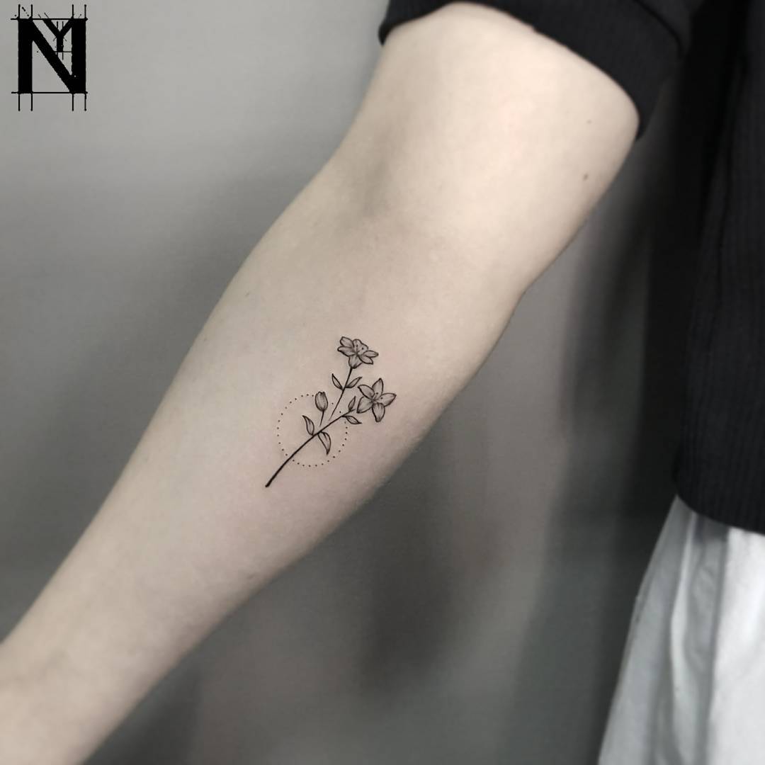 Tiny flower tattoo by Noam Yona