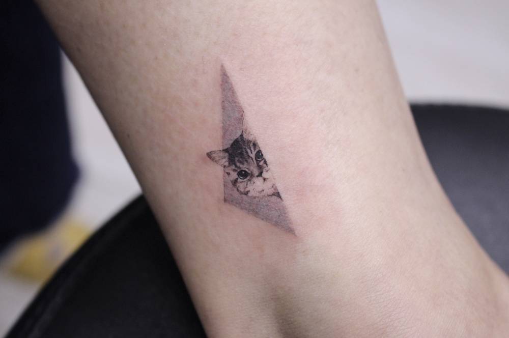Tiny kitten tattoo by Victoria Yam