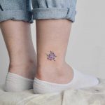 Violet flower tattoo on the ankle