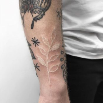 White leaf tattoo by Łukasz Krupiński