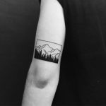 Beautiful minimal mountain tattoo by Chinatown Stropky