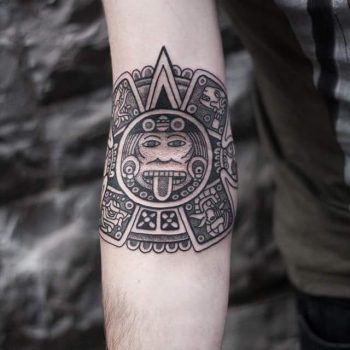 Center of Aztec calendar stone tattoo by Wagner Basei