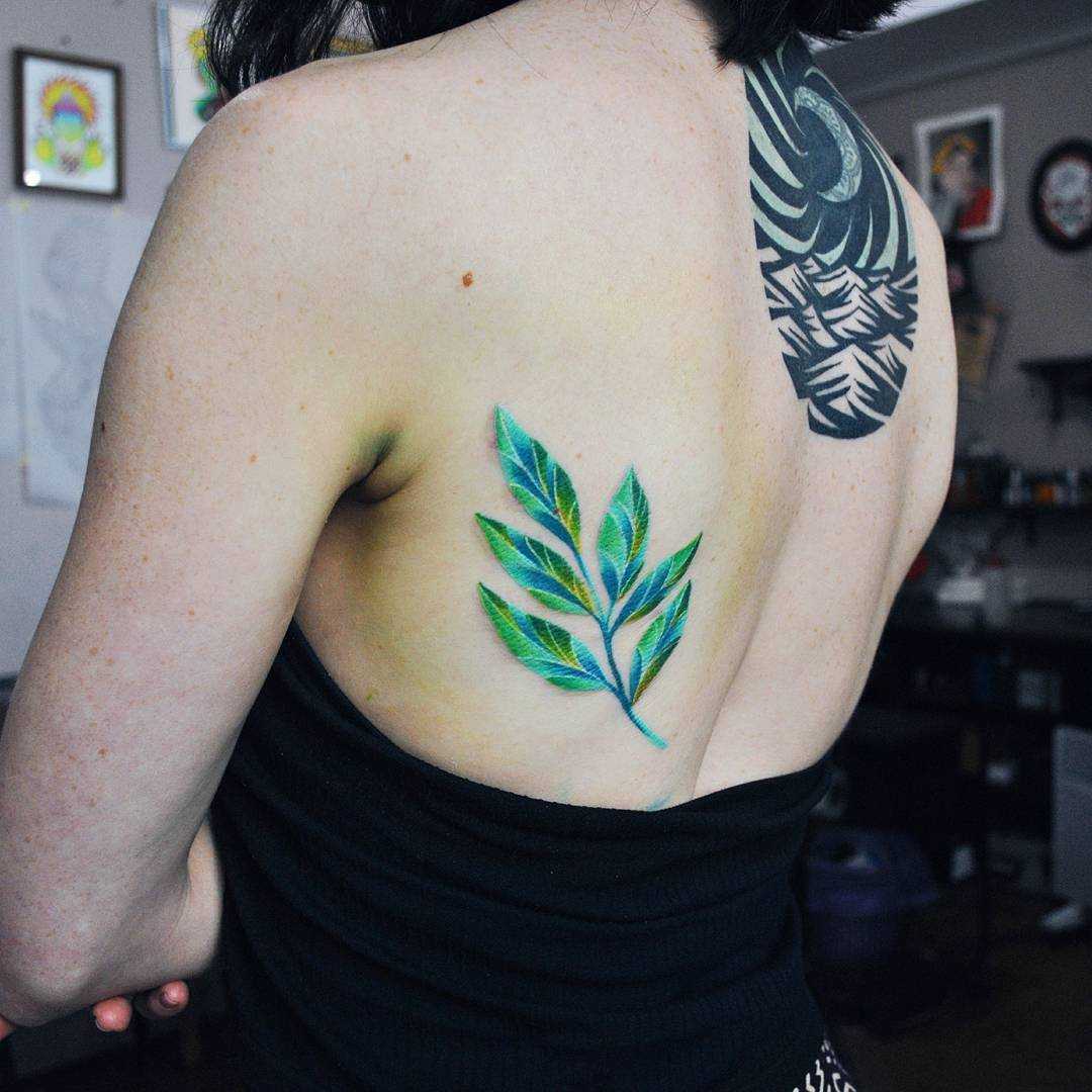 Green branch tattoo by Valeria Yarmola