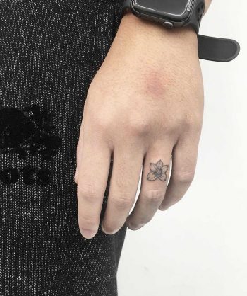 Hand-poked orchid tattoo by Gianina Caputo