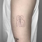 Kissing couple tattoo by Conz Thomas