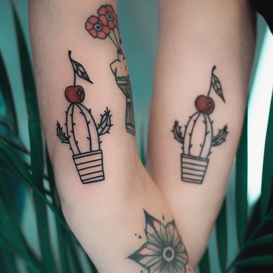 Matching cactus tattoos by Dżudi Bazgrole