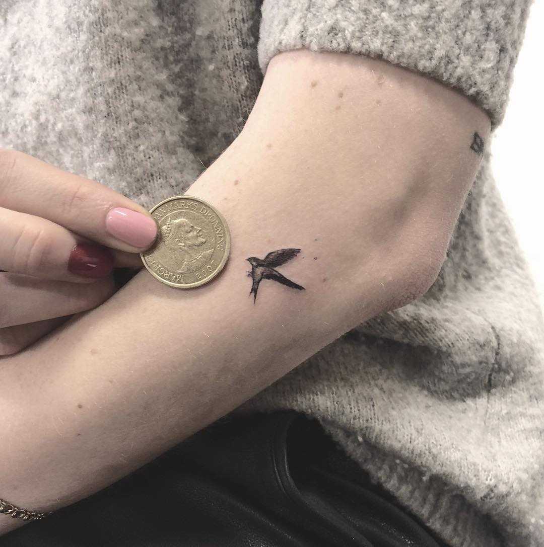 Micro swallow tattoo by Annelie Fransson