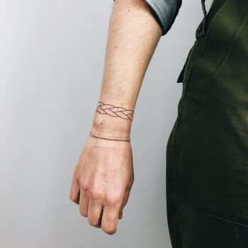 Minimalist woven bracelet tattoo by Kelli Kikcio