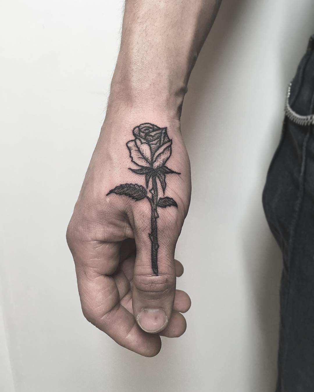 Rose tattoo on a thumb by tattooist Spence @zz tattoo