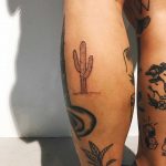 Small cactus tattoo on the calf by Kelli Kikcio