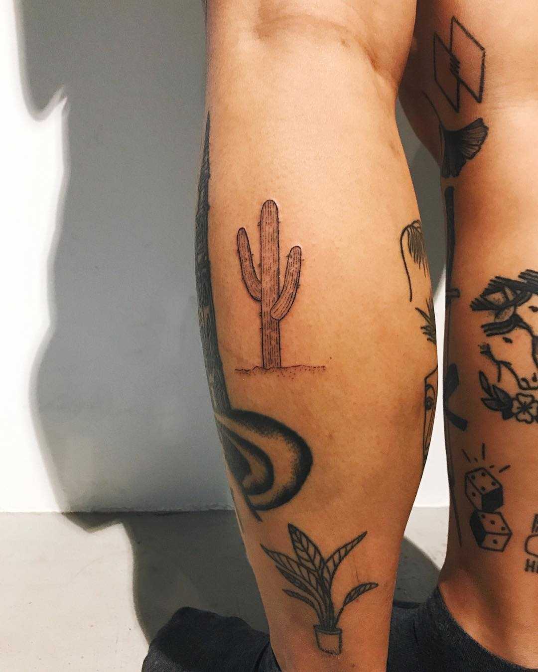 Small cactus tattoo on the calf by Kelli Kikcio