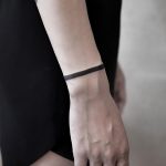 Solid black bracelet tattoo by Aki Wong