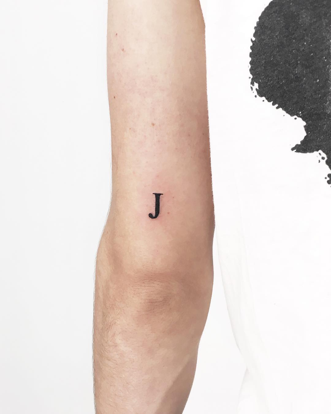 Tiny J tattoo by Gianina Caputo