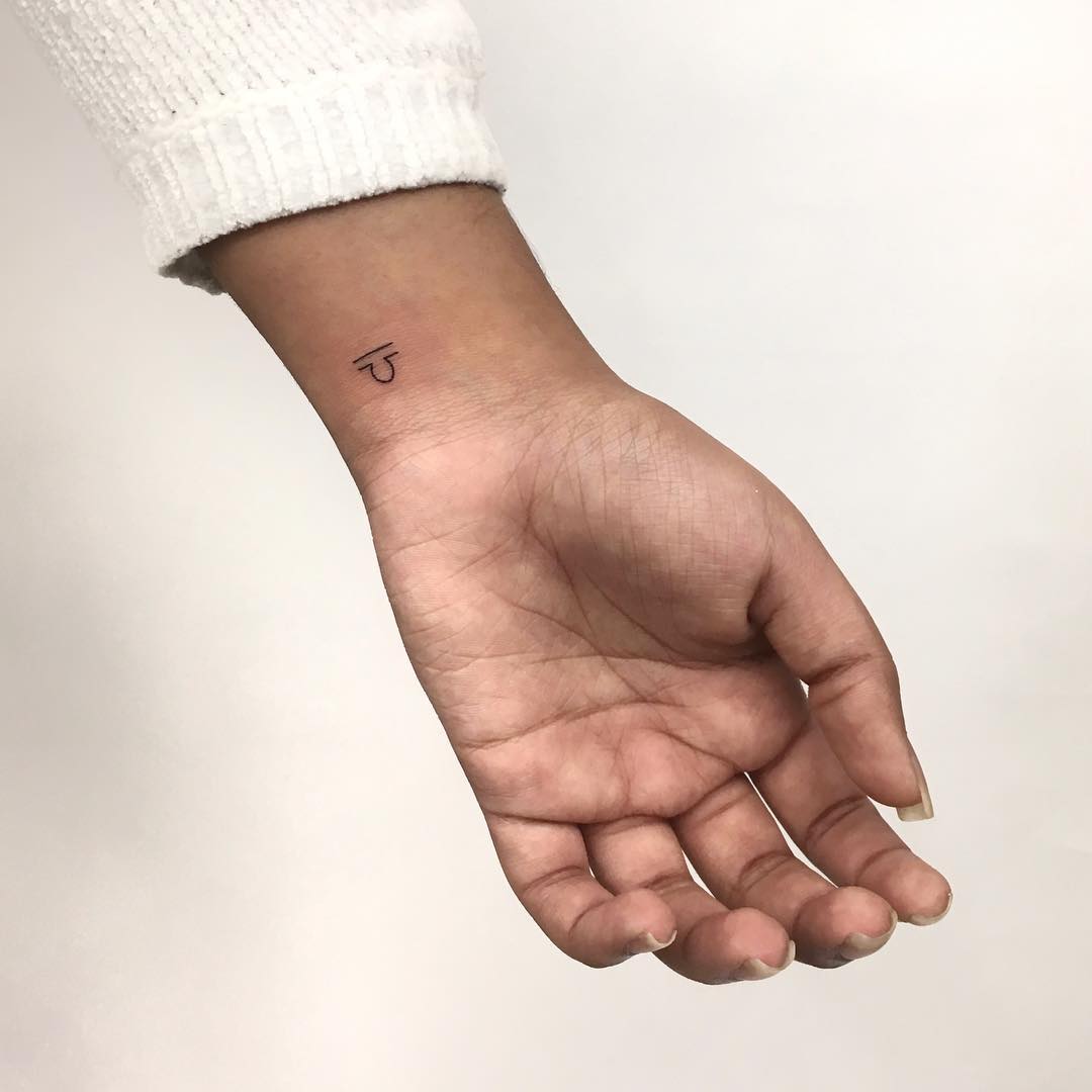 Tiny Libra sign tattoo by Gianina Caputo