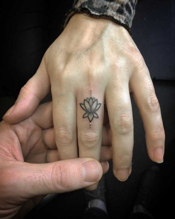 Tiny Lotus on the finger by Kirk Budden