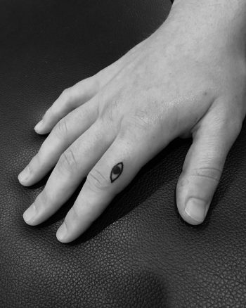 Tiny eye tattoo by Robbie Ra Moore