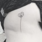A thin poppy tattoo by Annelie Fransson