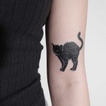 Black cat tattoo by Ann Gilberg