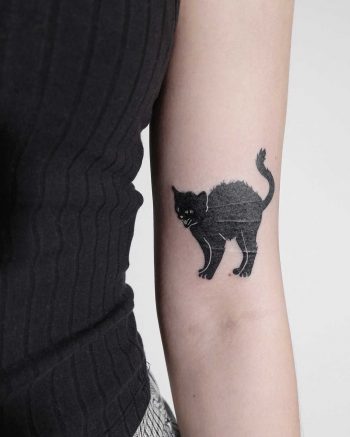 Black cat tattoo by Ann Gilberg