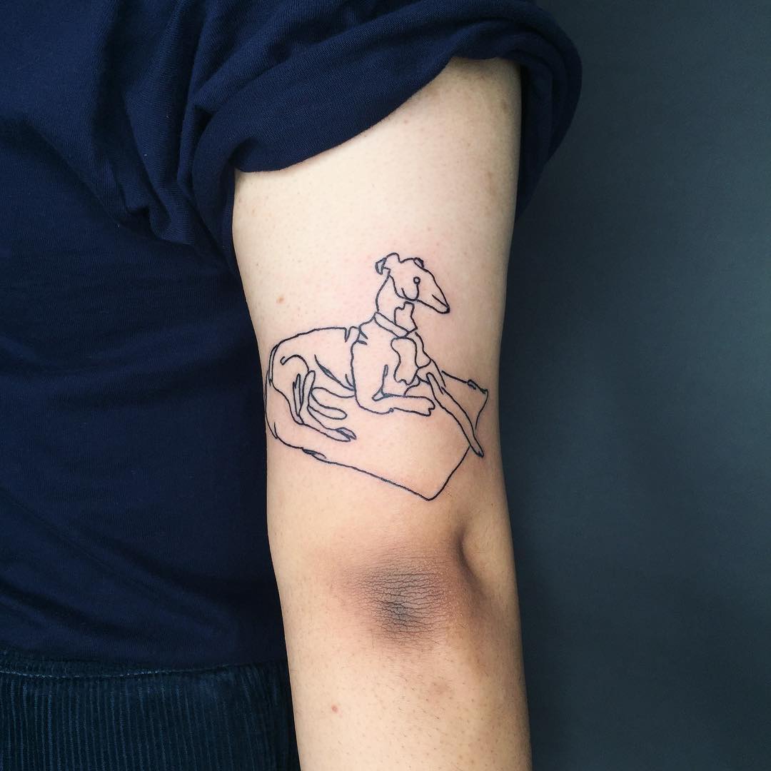 Chilling greyhound tattoo by Suki Lune