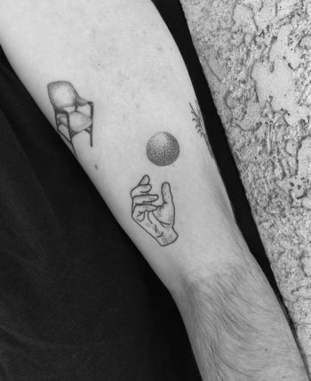 Hand and orb tattoo by Robbie Ra Moore