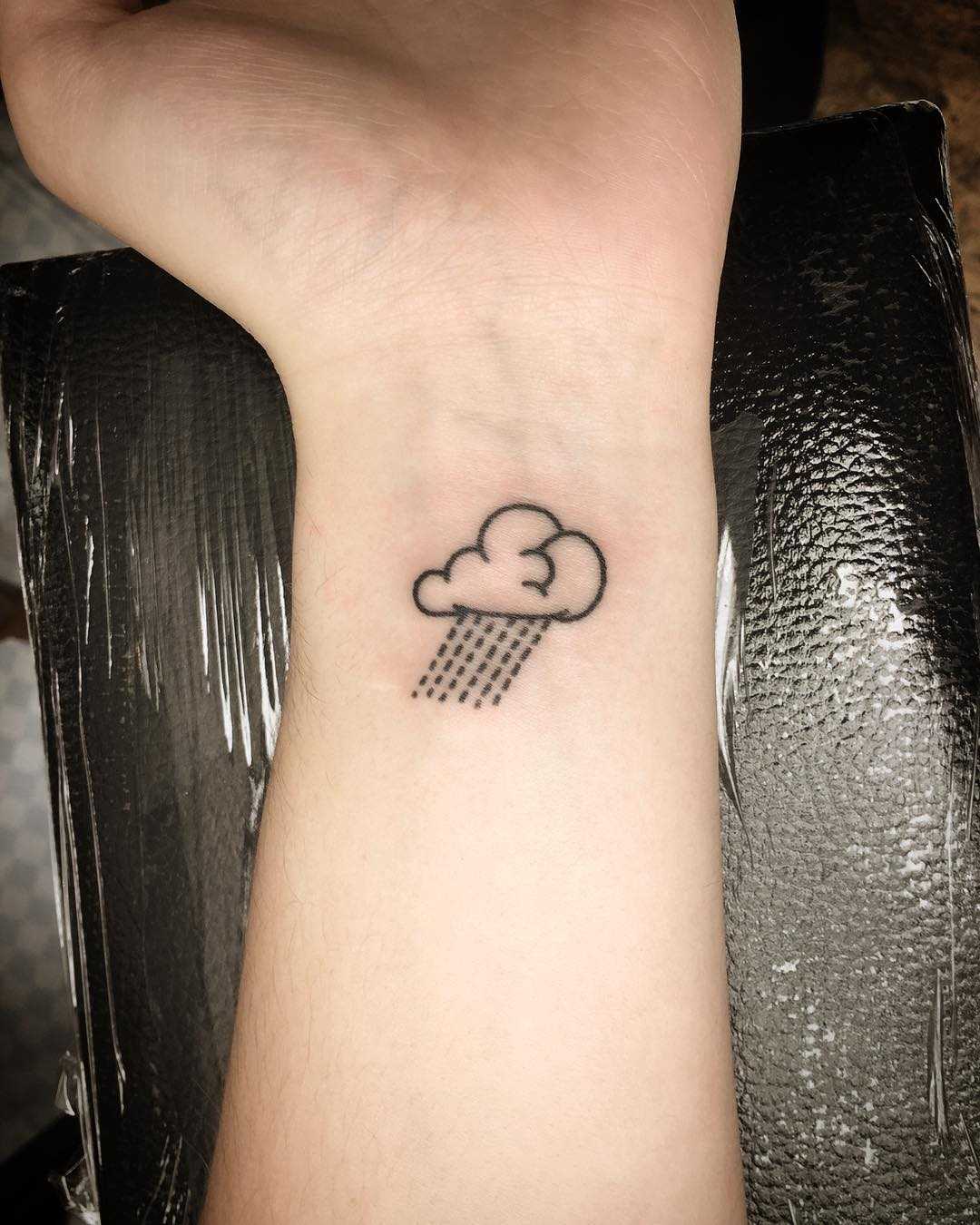 Hand-poked rain cloud tattoo by Kirk Budden